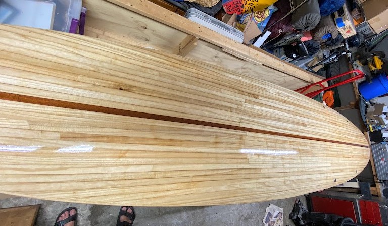 first coat of varnish applied to paddleboard