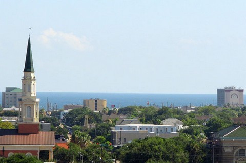 View of church steeple, rooftops and Gulf in the distance.